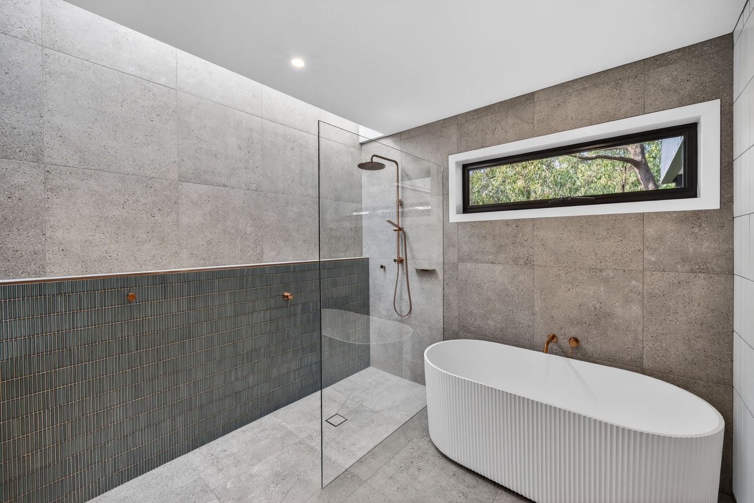 Bathroom featuring a bathtub and natural lighting,  clean architectural lines, and a calm, spa-like interior atmosophere