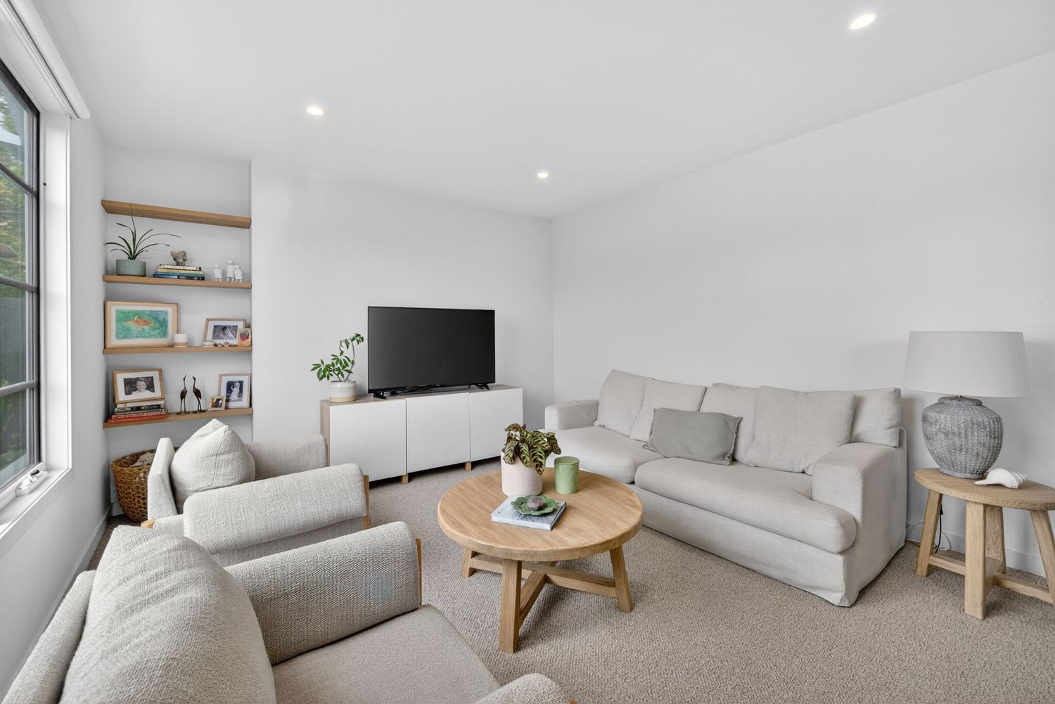 Informal lounge shot showing a relaxed living space with comfortable seating, soft natural light, and a casual, inviting interior style.