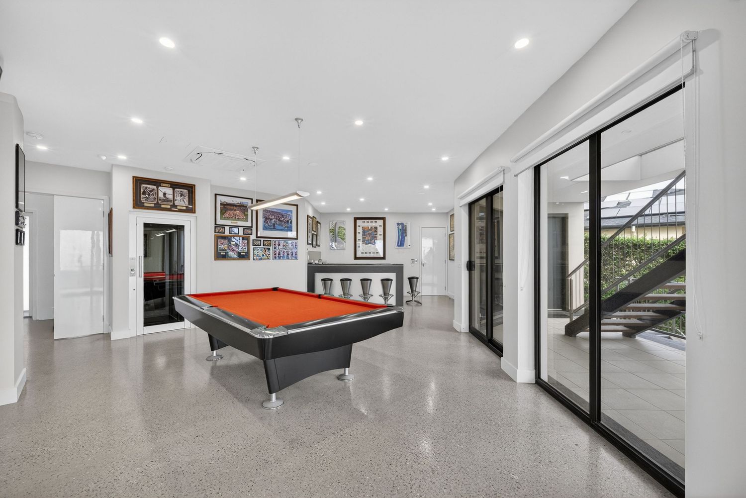 Pool room and bar featuring entertainment space with billiards table, integrated bar area, and stylish interior design with ambient lighting