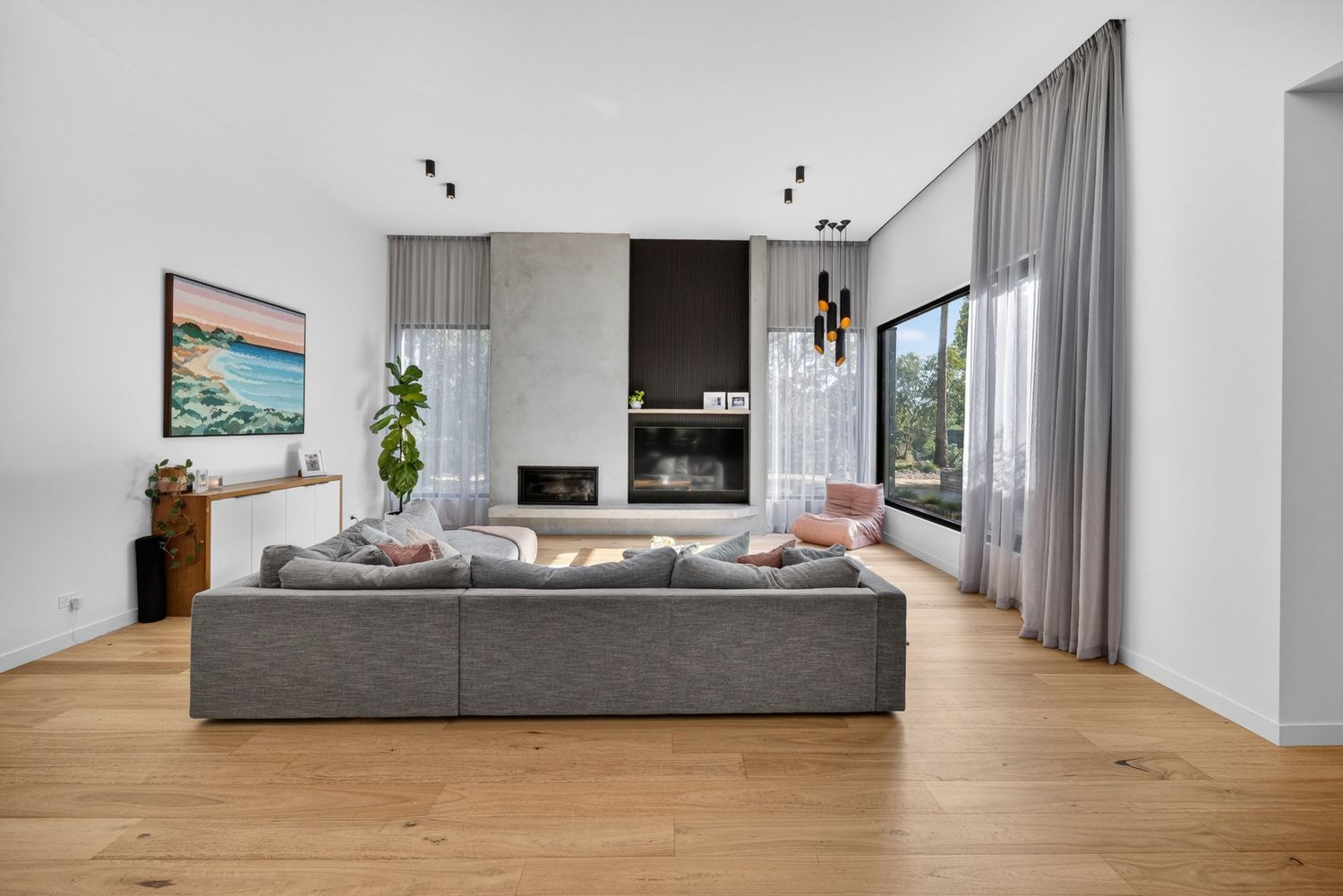 Lounge and dining wide shot showing open-plan living, natural light, and cohesive interior design flow between spaces.
