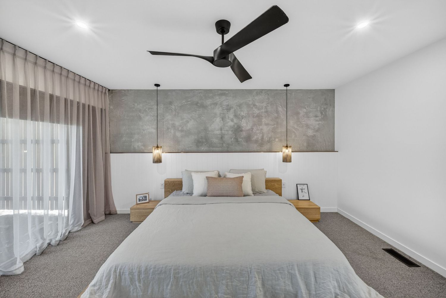 Master bedroom with soft natural light, calm styling, and modern interior design details.