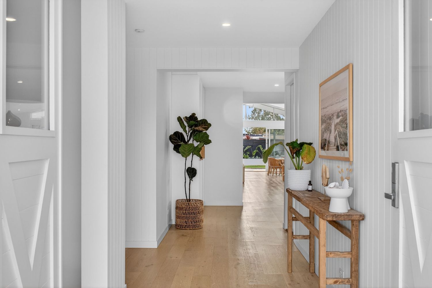 Front entryway and hallway of a storybook-style home, featuring warm architectural details, inviting natural light, and a refined interior l