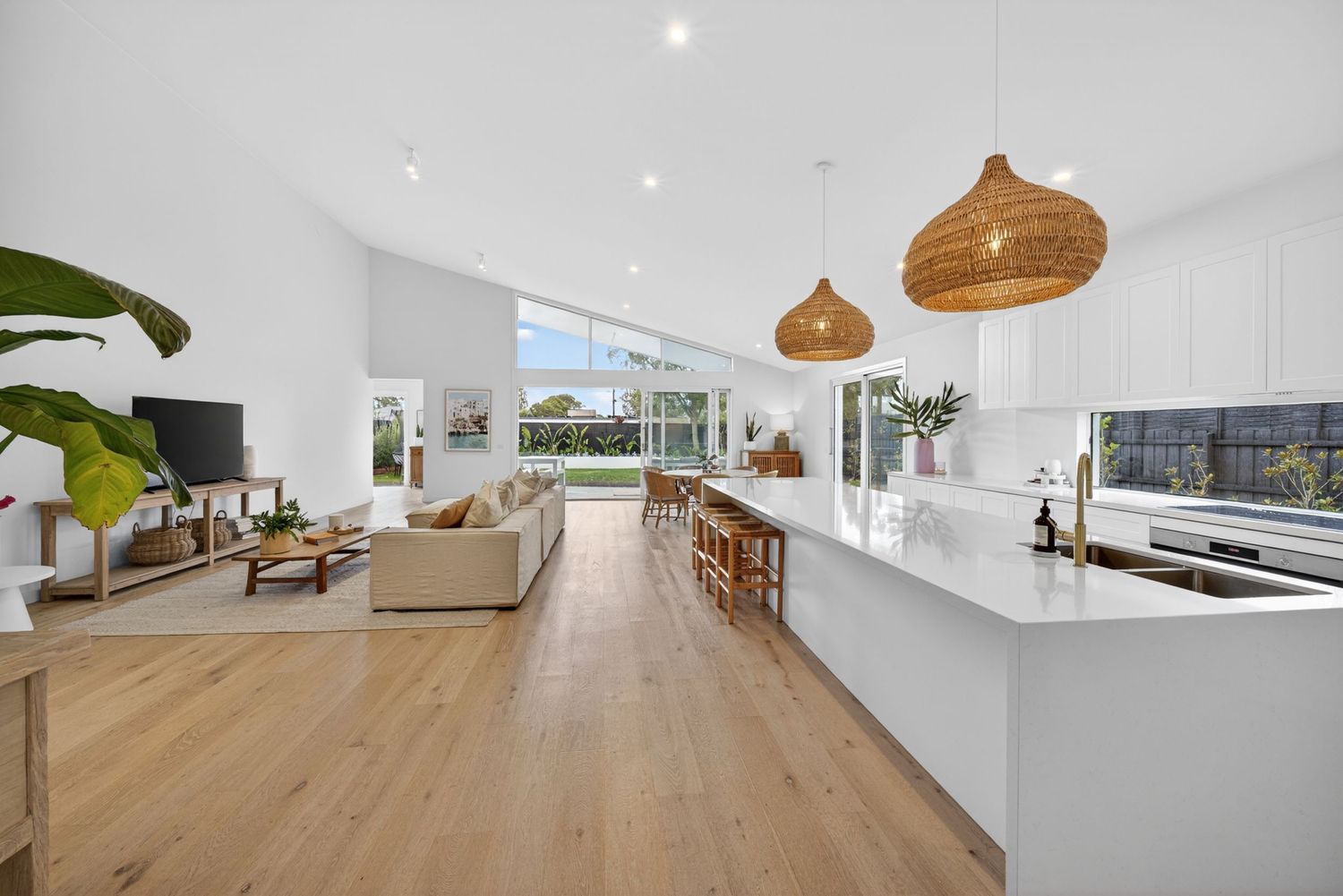 Kitchen & living room of a client’s home photographed by BWImagery, featuring open-plan living, natural light,and a cohesive modern interior