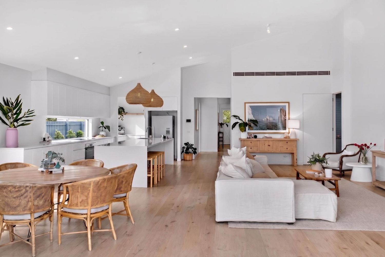 Kitchen & living room of a client’s home photographed by BWImagery, featuring open-plan living, natural light,and a cohesive modern interior