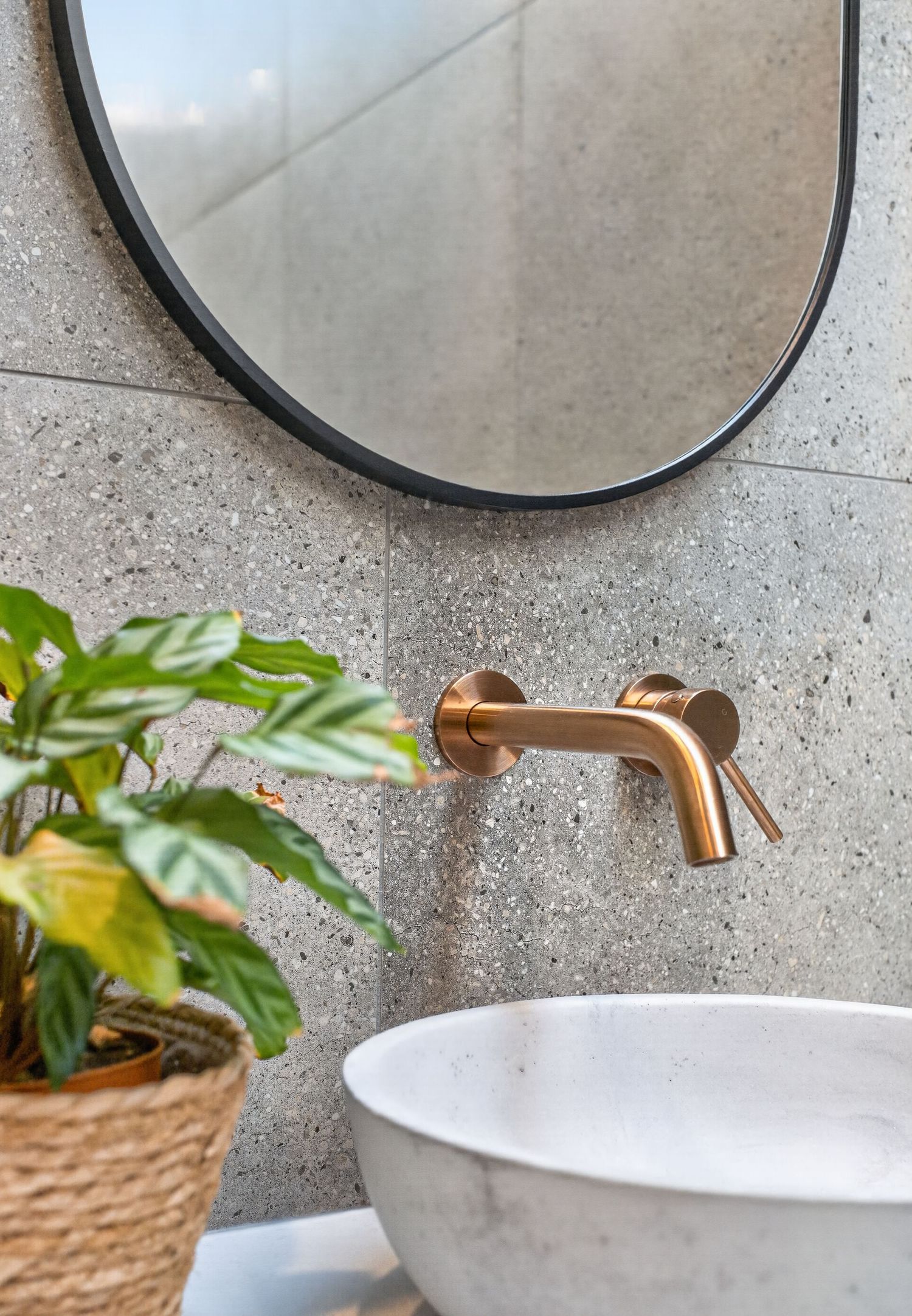 Feature design shot of a tap and mirror, highlighting bathroom fixtures, reflective surfaces, and considered interior styling