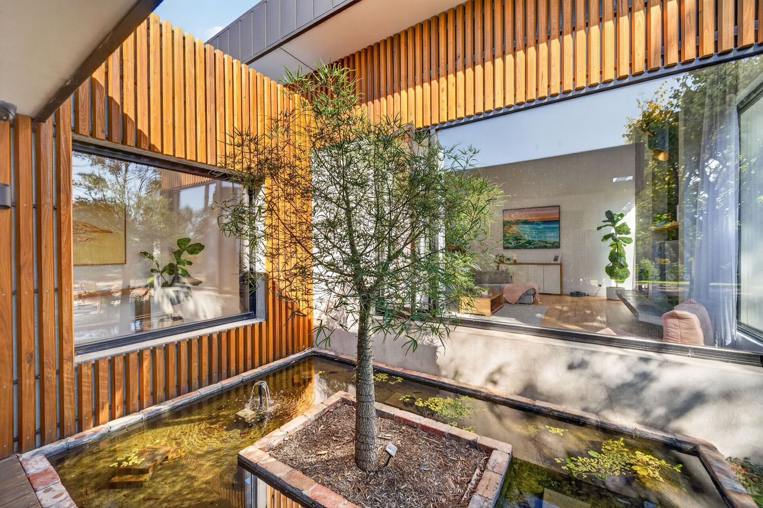 Entry to a client’s home featuring a water feature, showcasing a welcoming architectural entrance with flowing water, landscaping elements