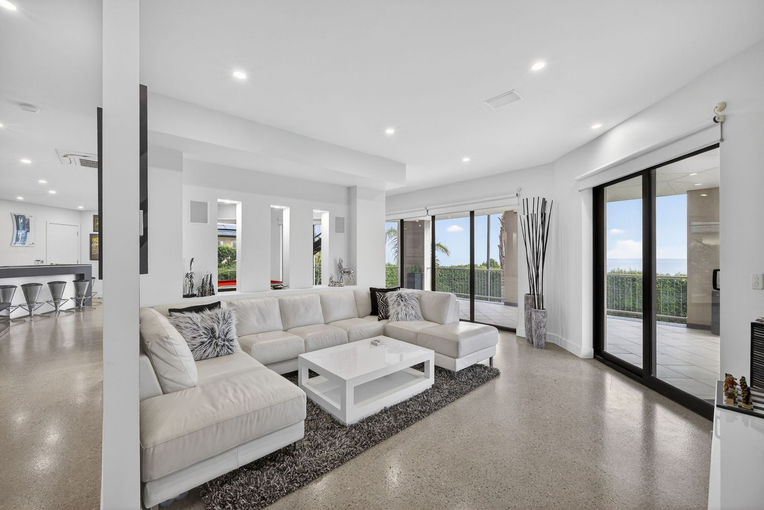 Second living area featuring relaxed lounge space, comfortable seating, and cohesive interior design with natural light and modern styling