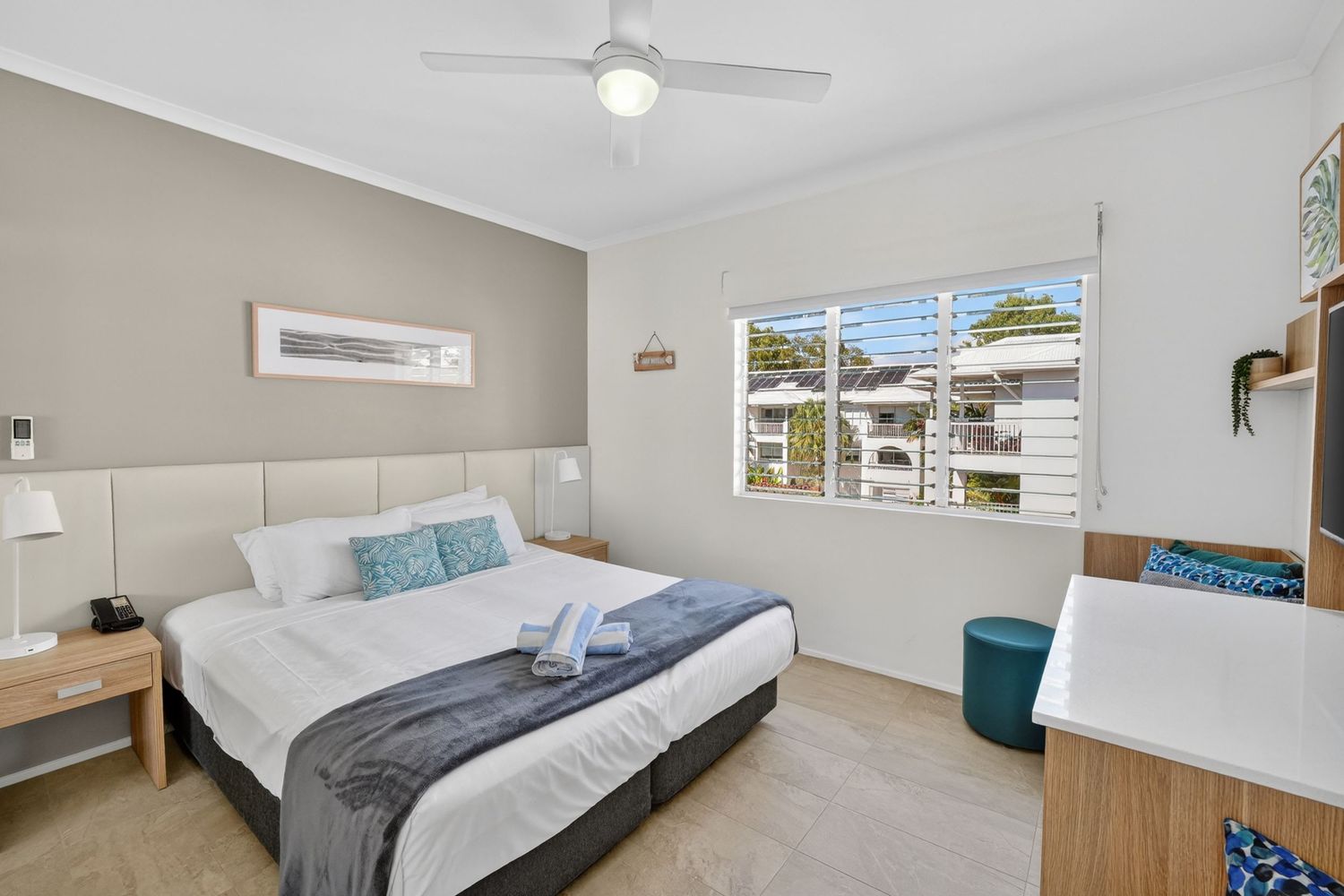 Bedroom of a holiday apartment featuring relaxed, modern styling, soft natural light, and a calm, comfortable resort-inspired atmosphere.
