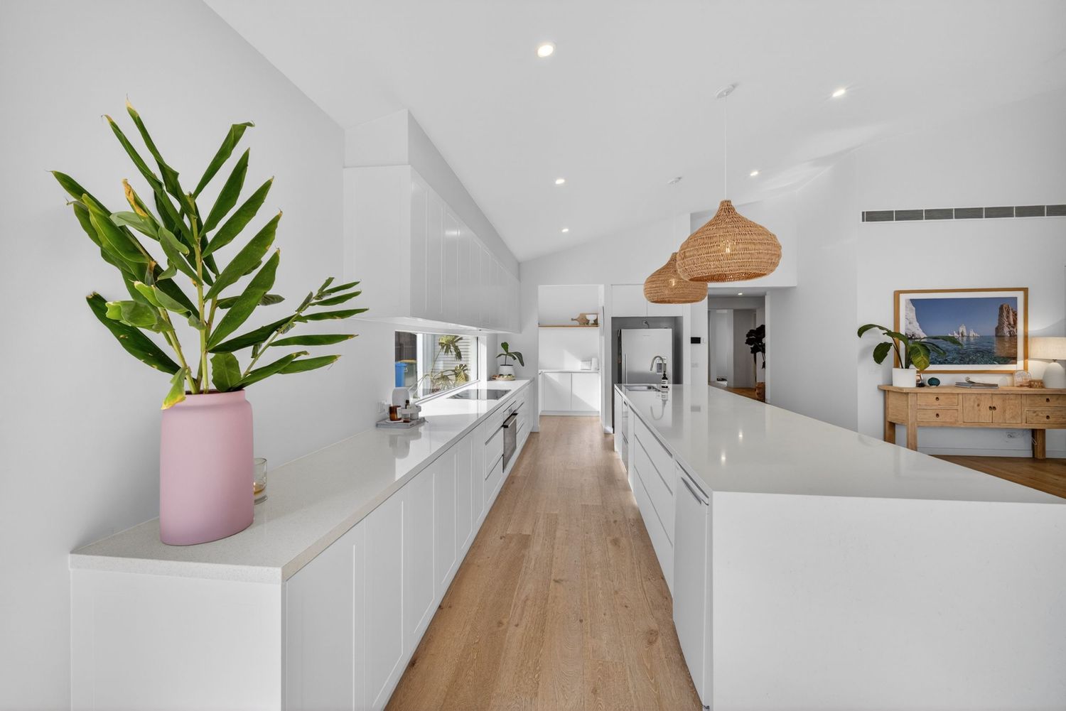 Long perspective shot down the length of a kitchen captured by BWImagery, highlighting clean lines, cabinetry, and cohesive interior design