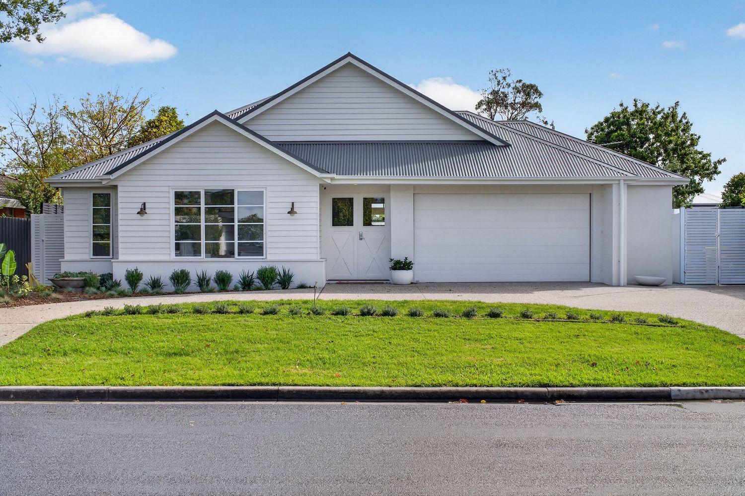Exterior street view of a storybook-style home, showcasing charming architectural details, landscaped frontage, and a welcoming entry