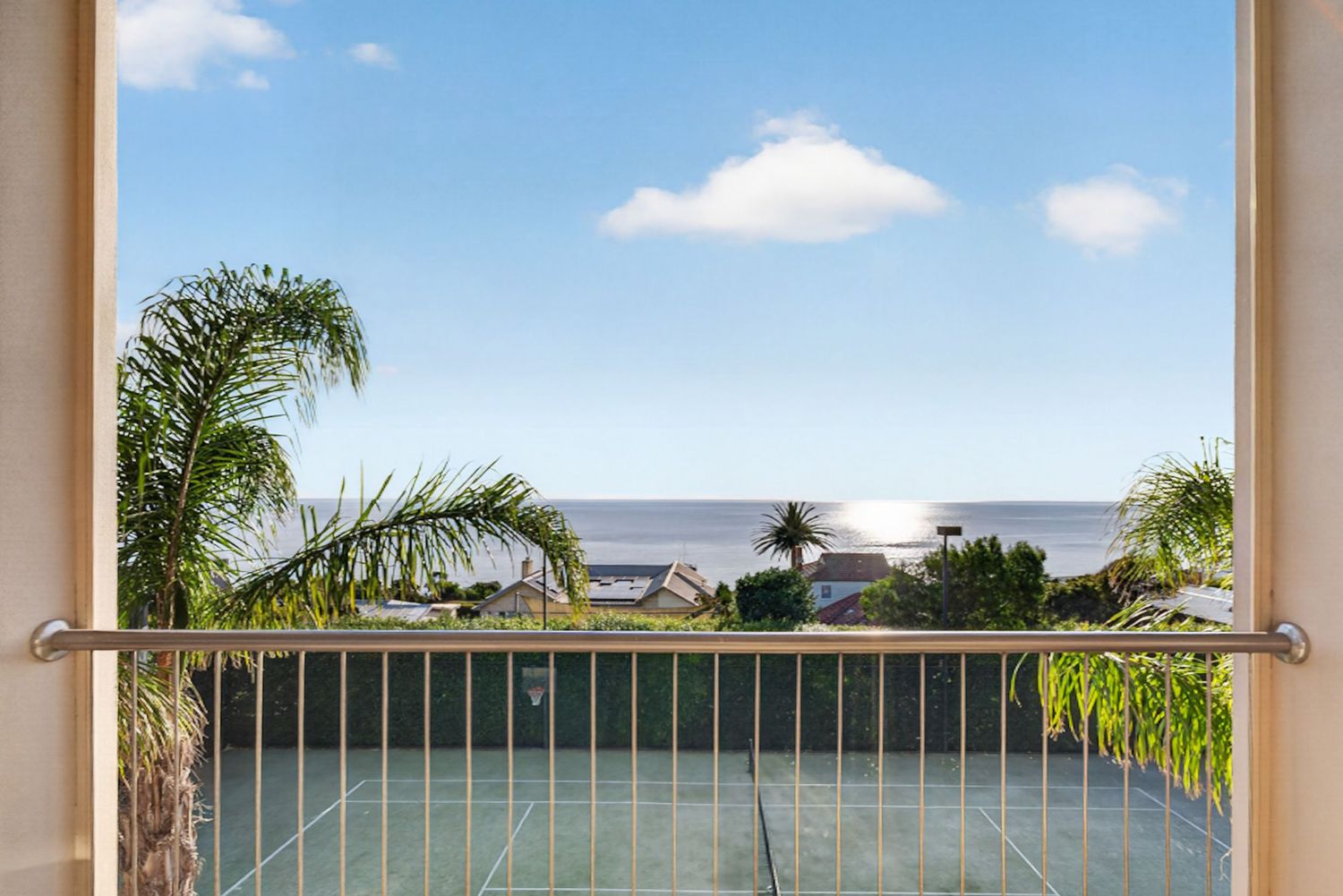 Shot of ocean view from balcony, showcasing open horizon, natural light, and a relaxed coastal outlook from an elevated perspective.