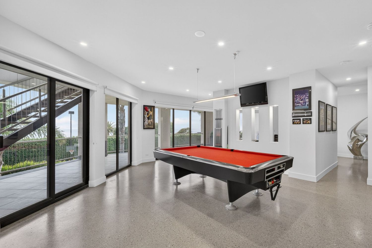 Pool room and bar featuring entertainment space with billiards table, integrated bar area, and stylish interior design with ambient lighting