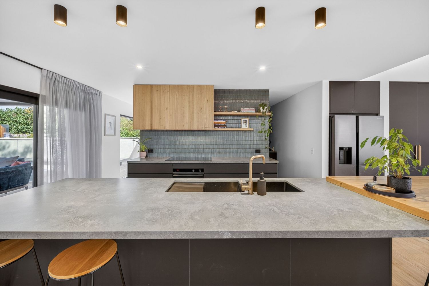 Focused shot of kitchen, highlighting cabinetry, benchtops, fixtures, and design details with clean lines and natural light