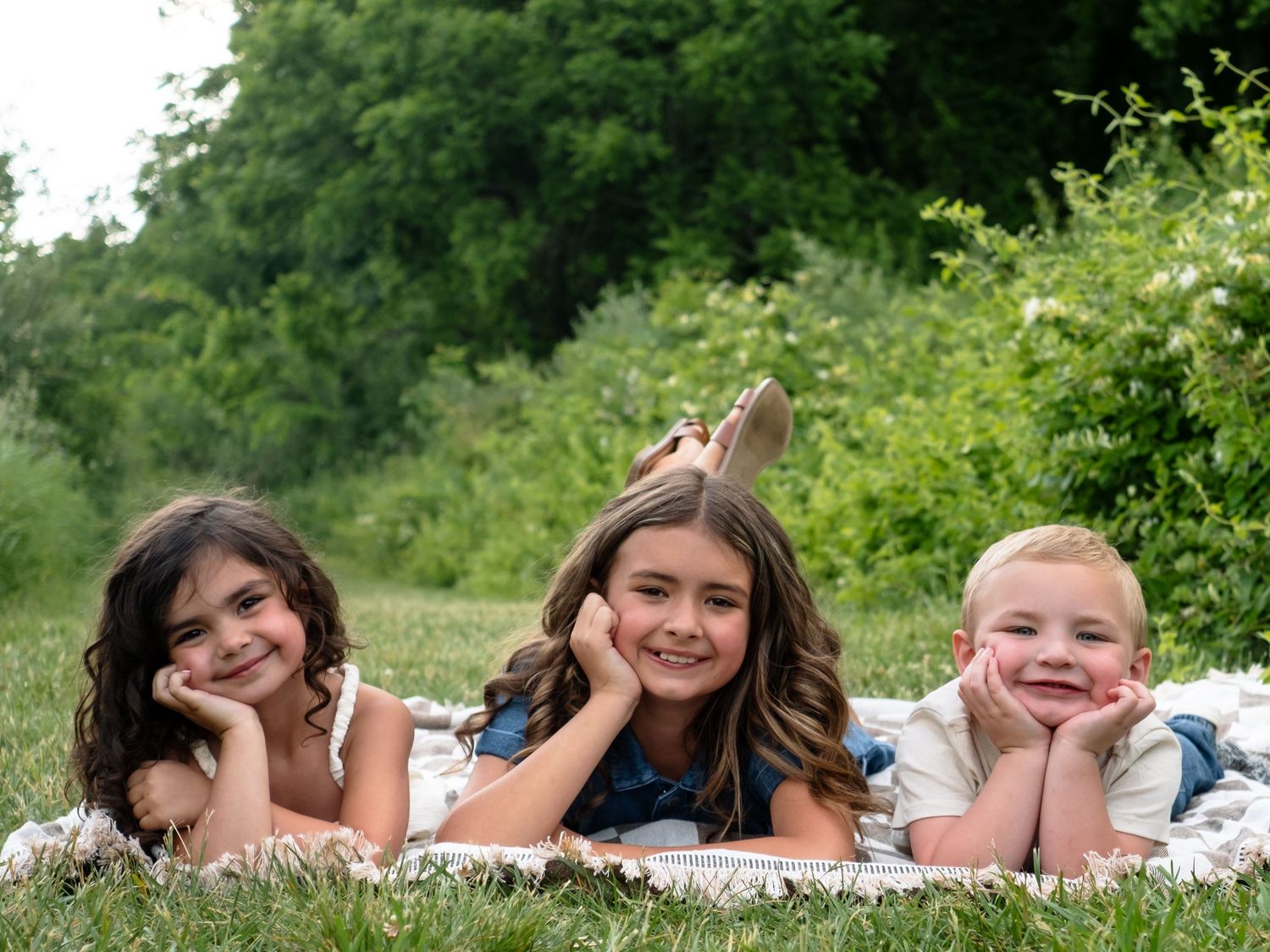 siblings smiling in field at middle creek