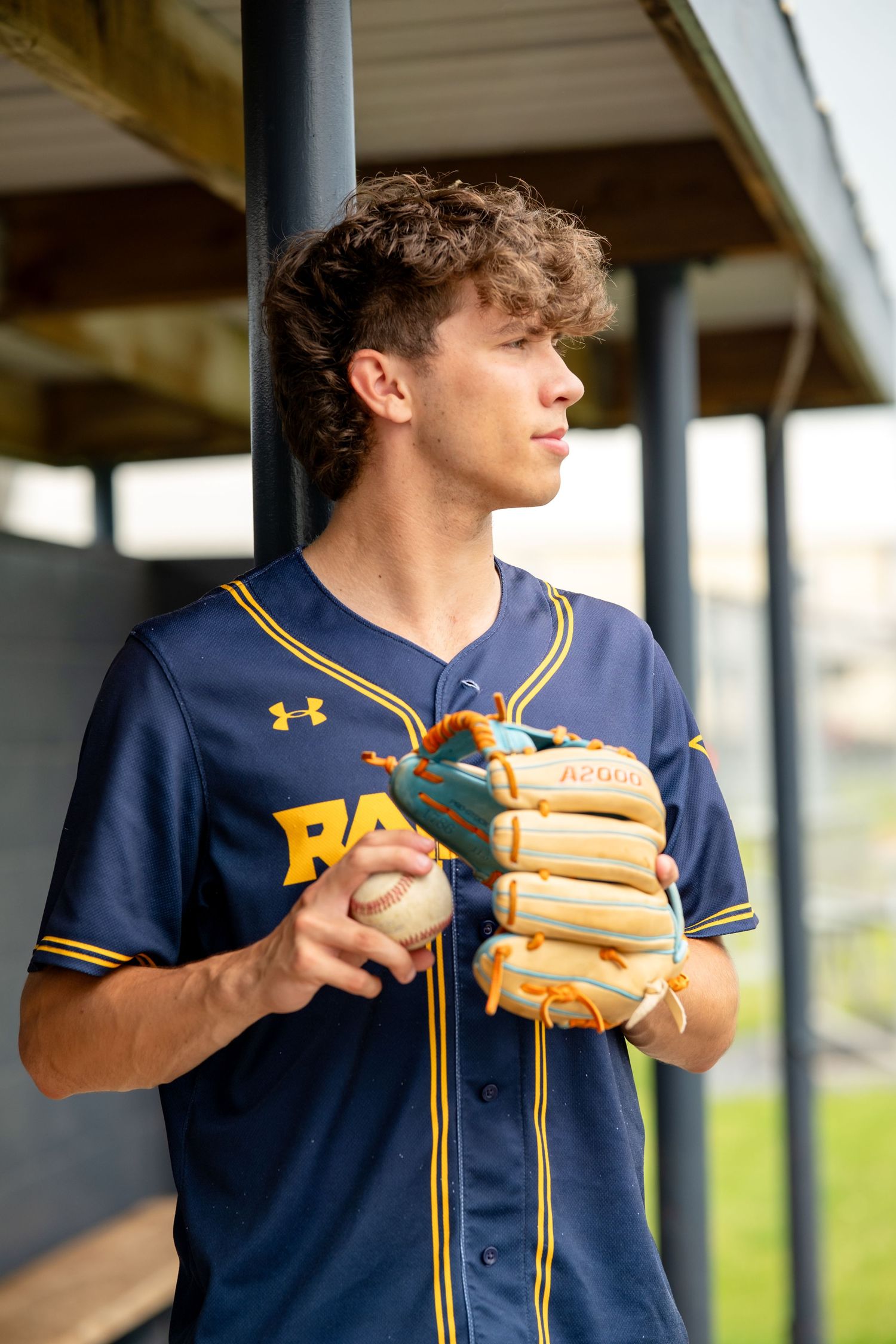 senior boy with glove and baseball
