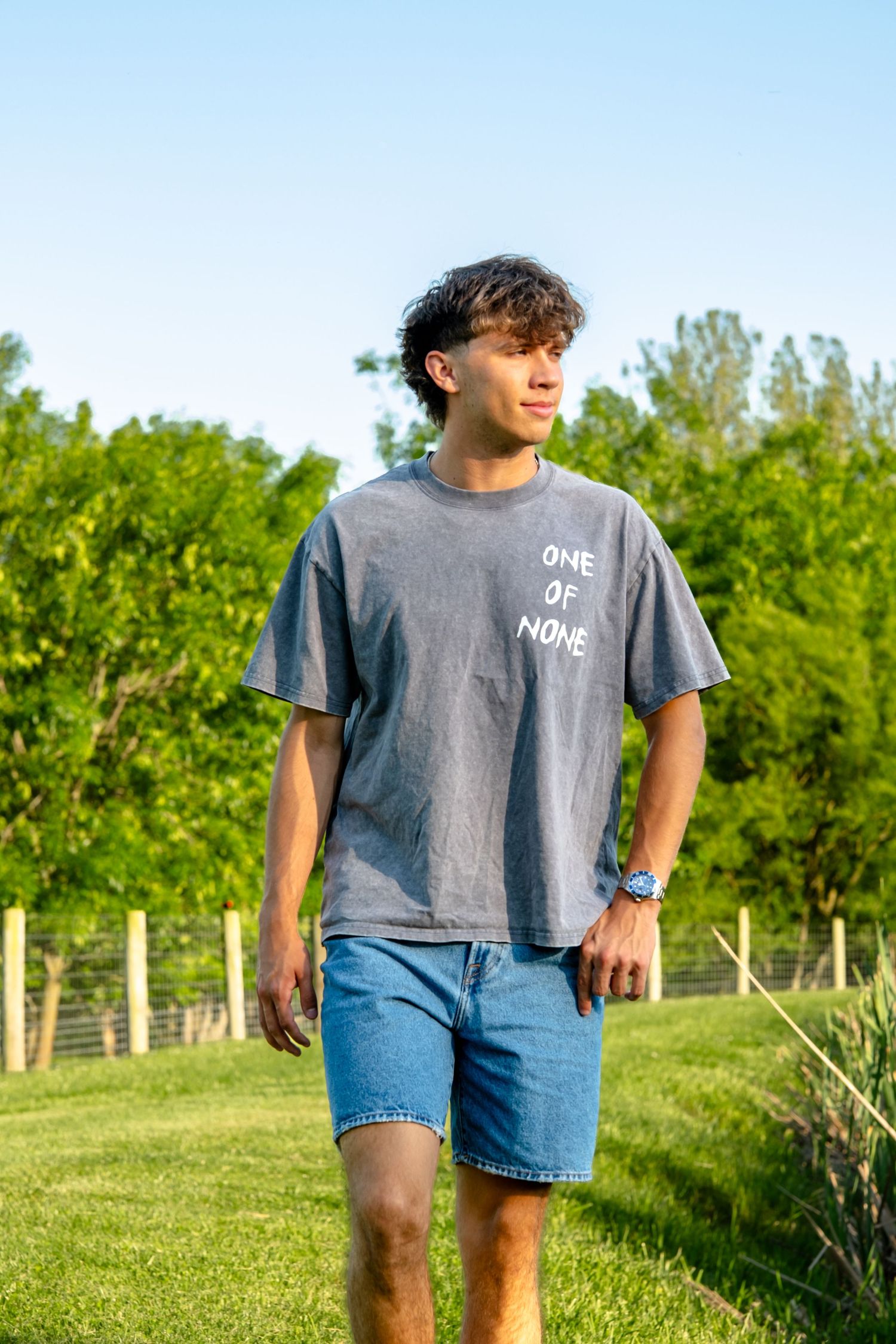 senior boy walking around pond at Elizabeth farms