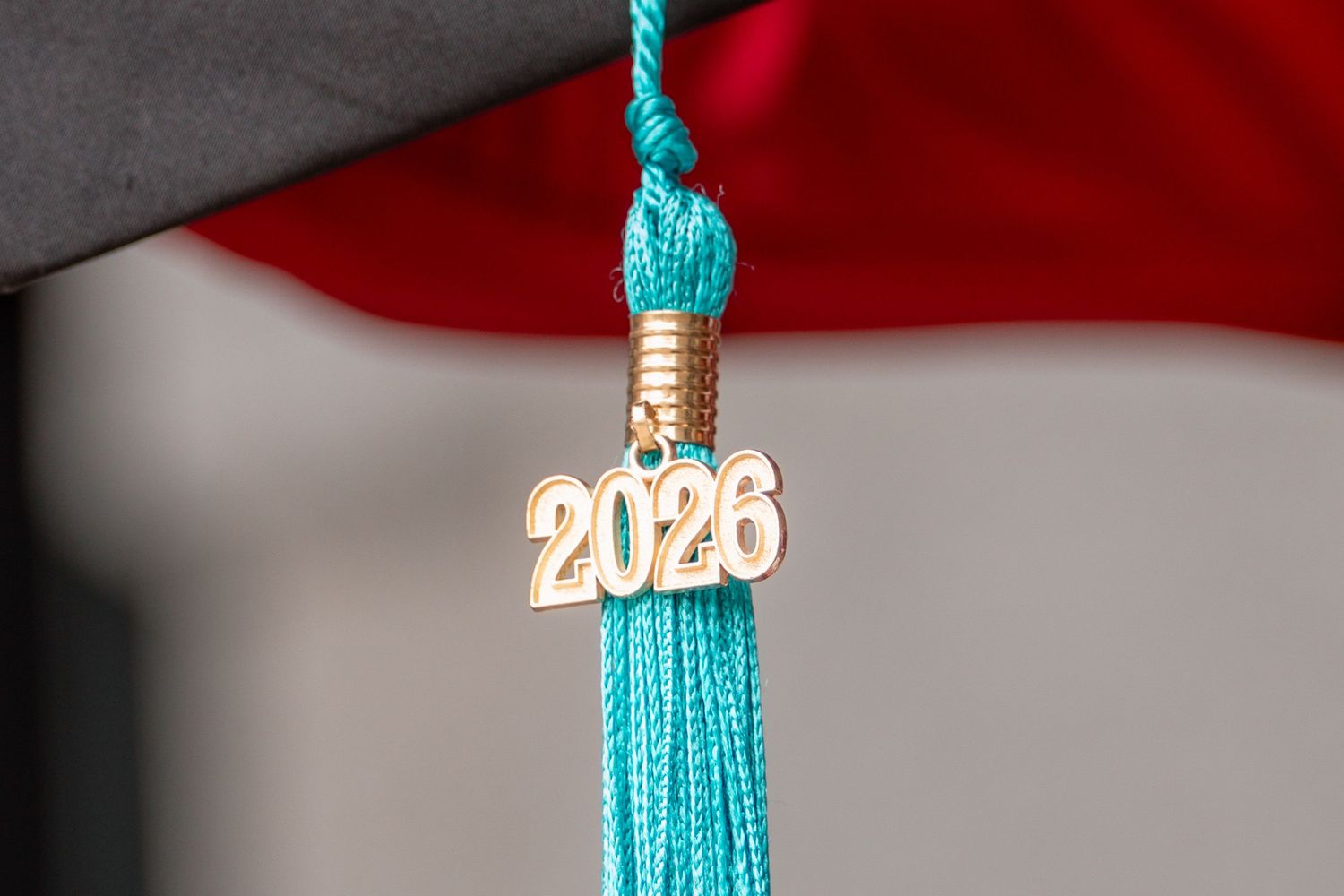 Close-up of teal graduation tassel with gold 2026 charm on academic mortarboard cap in Littleton, Colorado.
