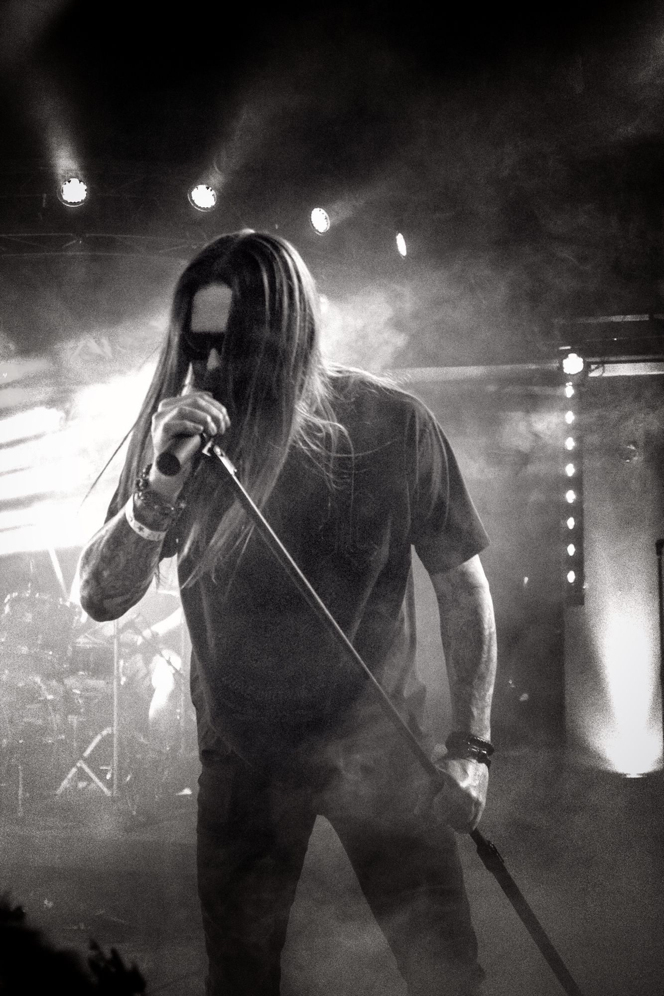 A black and white photo of a rock musician performing on stage