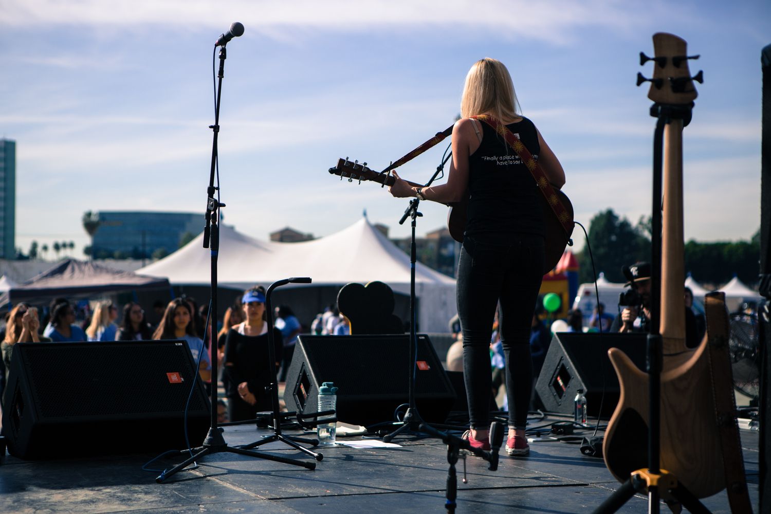 A folk singer performs outdoors at an event