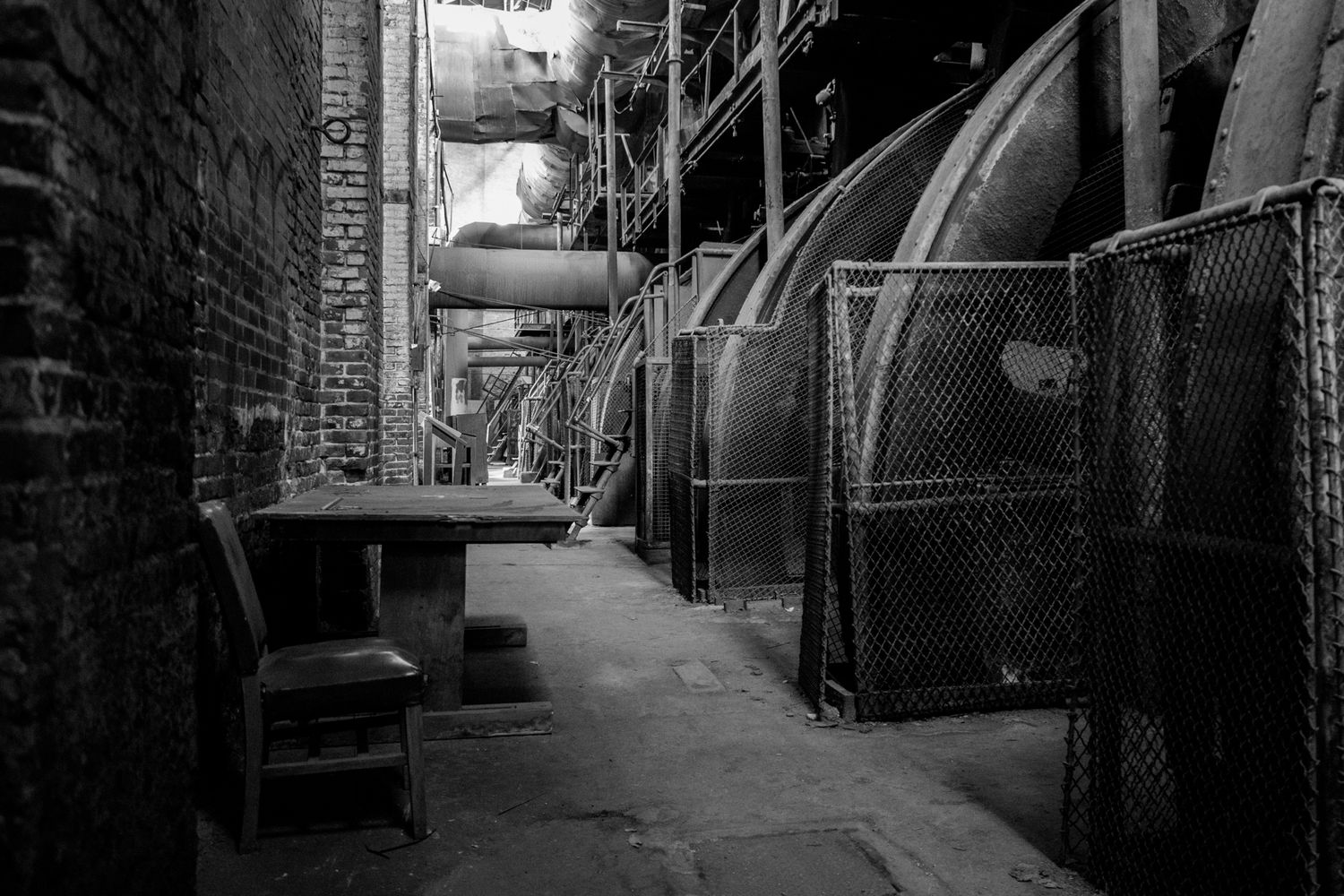 A black and white interior scene at an iron mill