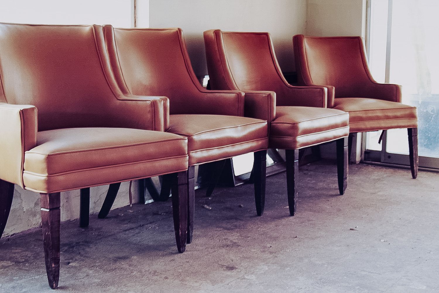 A row of empty chairs in an abandoned hotel