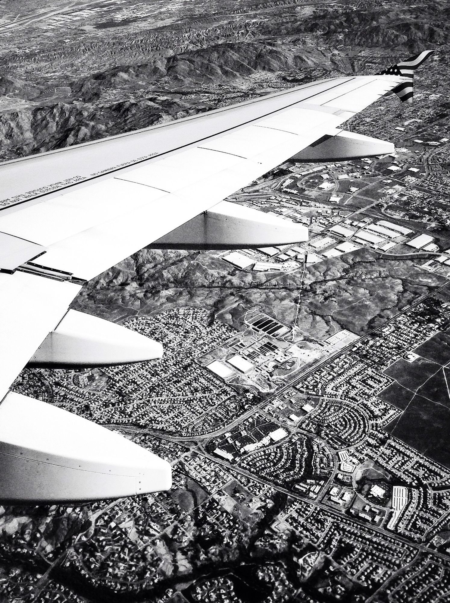 Ariel view of an airplane wing and the city below