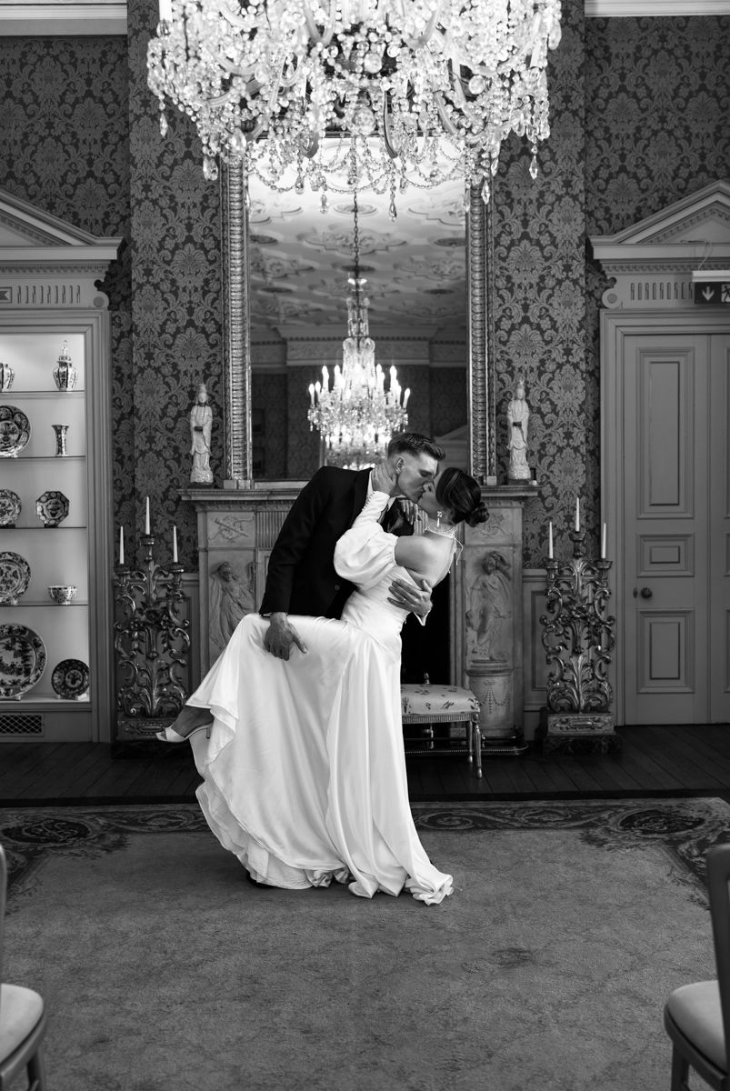 Bride and groom kiss photo in ball room Capesthorne Hall - editorial timeless wedding photographer Cheshire