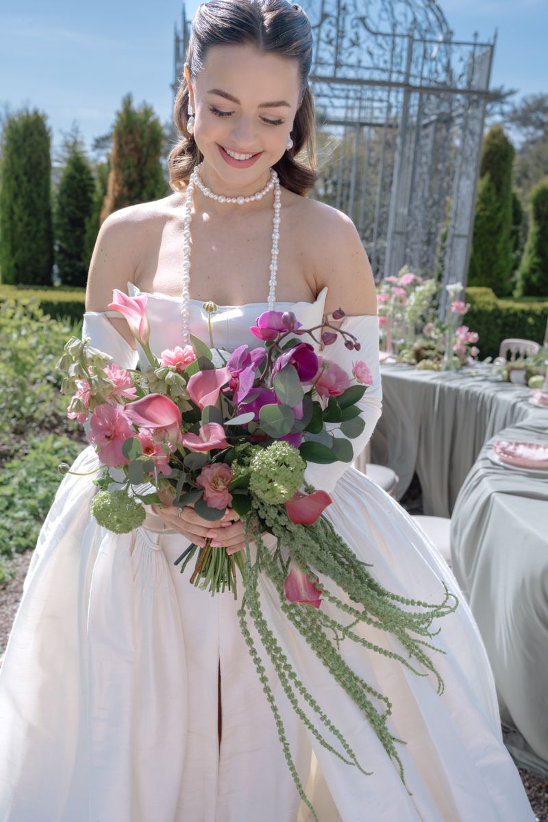 Bride with her wedding bouquet - a portrait at the gardens in Capesthorne Hall - editorial wedding photographer in Cheshire