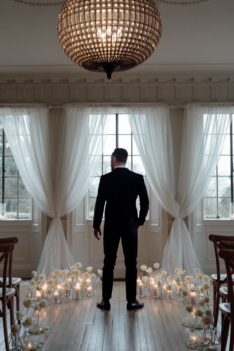 Groom portrait by the window at Eaves Hall, Lancashire  - editorial wedding photographer  in Lancashire