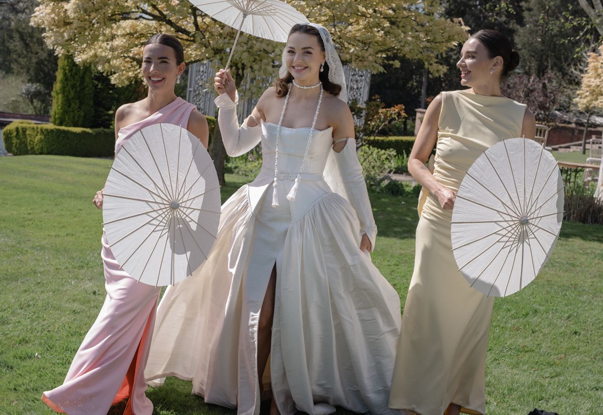 Bride walking the grounds of Capesthorne Hall with her bridesmaids - editorial wedding photographer Cheshire