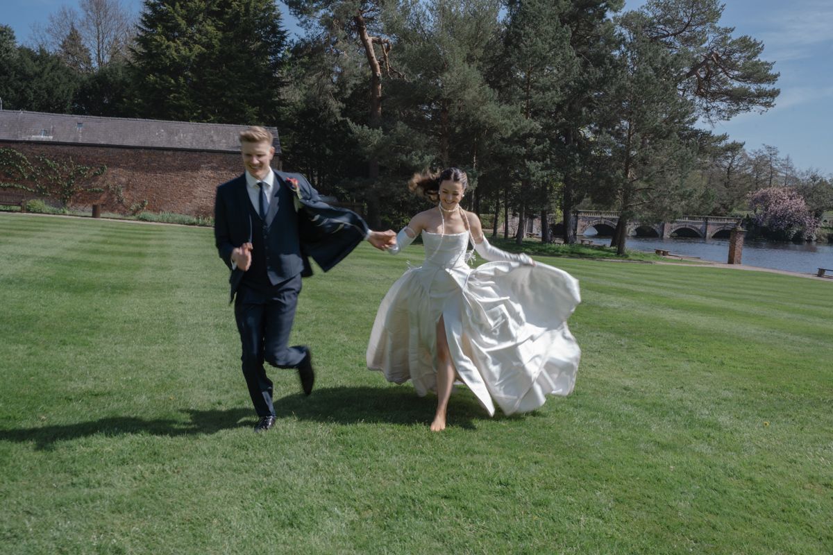 Bride and groom running the grounds of Capesthorne Hall - editorial bridgerton style wedding photography Cheshire