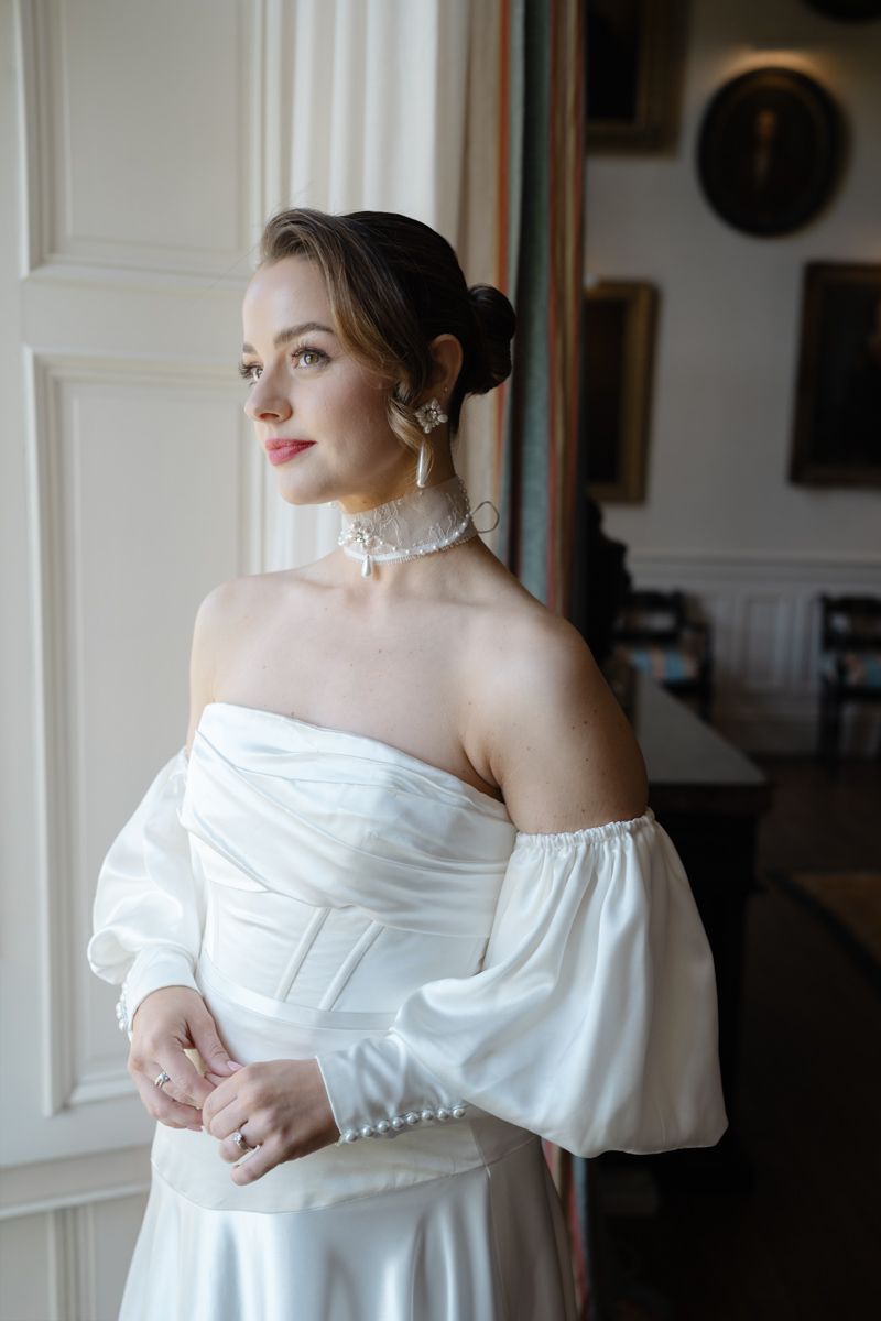 Bride editorial portrait by the window in Capesthorne Hall - editorial wedding photographer in Cheshire