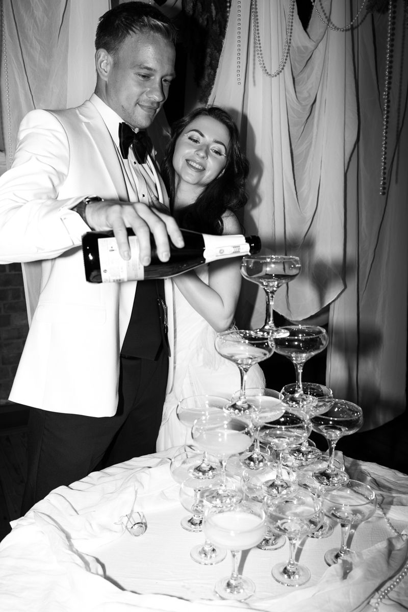 Champagne tower classic hollywood bride and groom shot  in Castlefield rooms, Manchester - editorial wedding photographer  Manchester