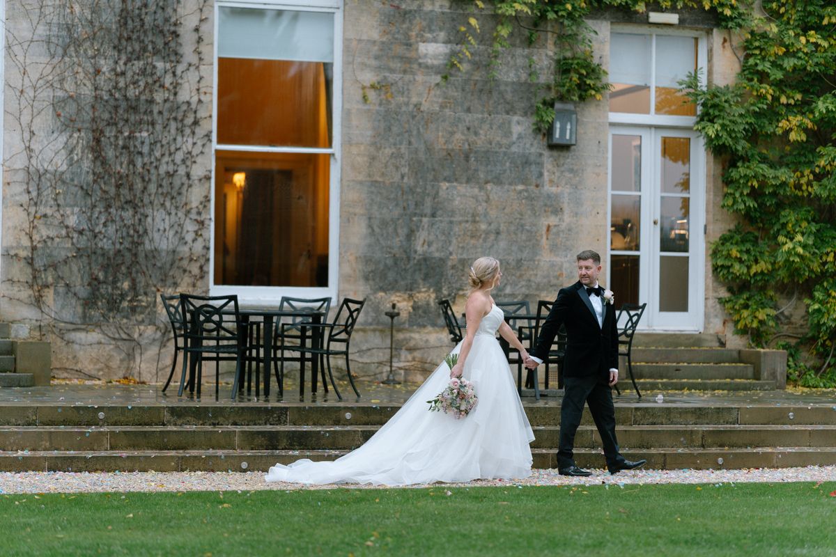 Bride and groom walking the grounds at Bowcliffe Hall - editorial wedding photography Yorkshire