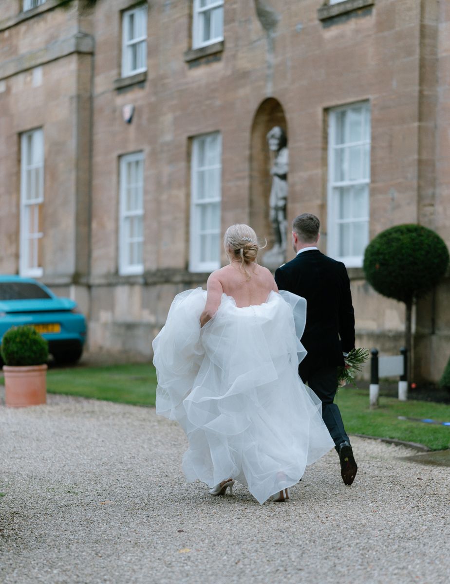 Bride and groom walking the grounds of Bowcliffe hall - editorial wedding photographer Yorkskhire