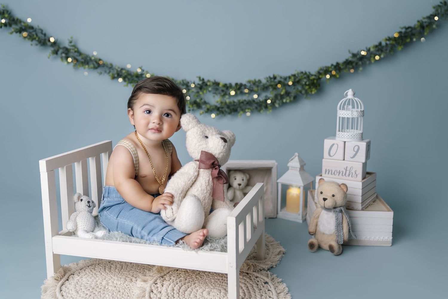 Baby sits on white wooden bench with teddy bear, newborn , maternity and family photographer attending morgan hill california