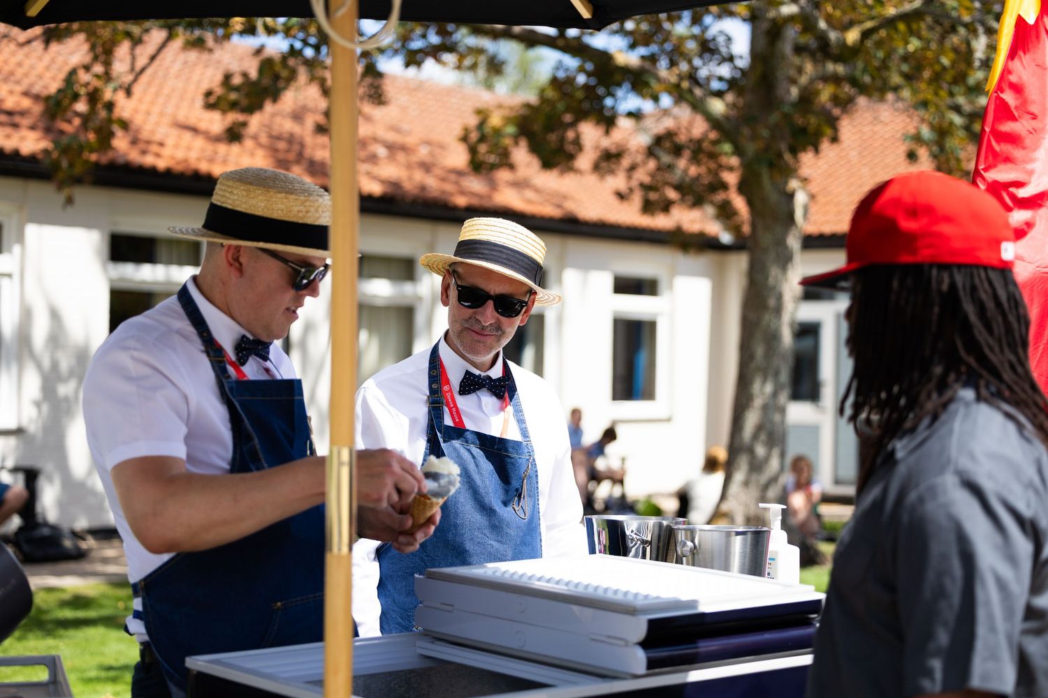 People gathered outdoors for a casual networking event or meeting on a sunny day.