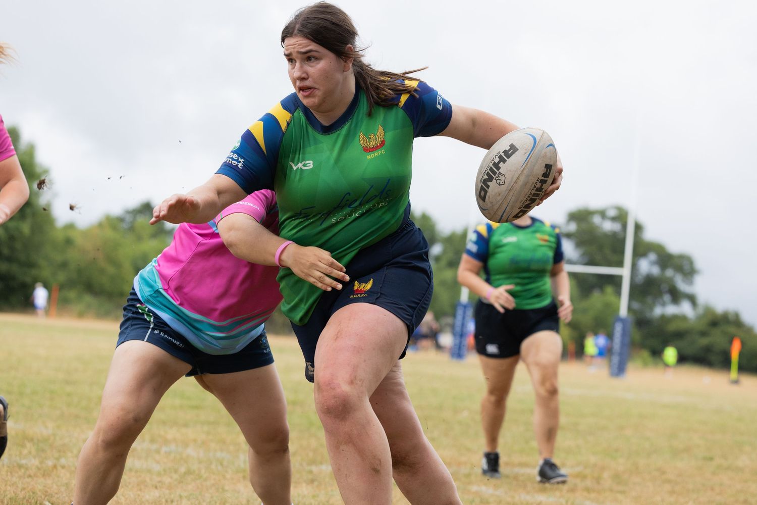 Rugby players engaged in a physical battle for ball possession during a match.