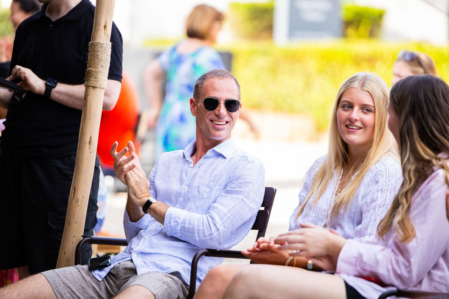 Group of friends enjoying casual outdoor gathering on sunny day.