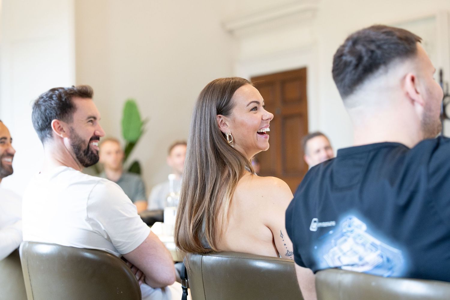 Group of attendees sharing a jovial moment during a conference or meeting.