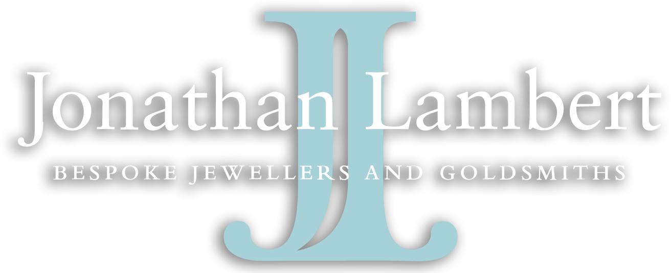 Jonathan Lambert bespoke jewellers logo featuring initials JL in light blue.