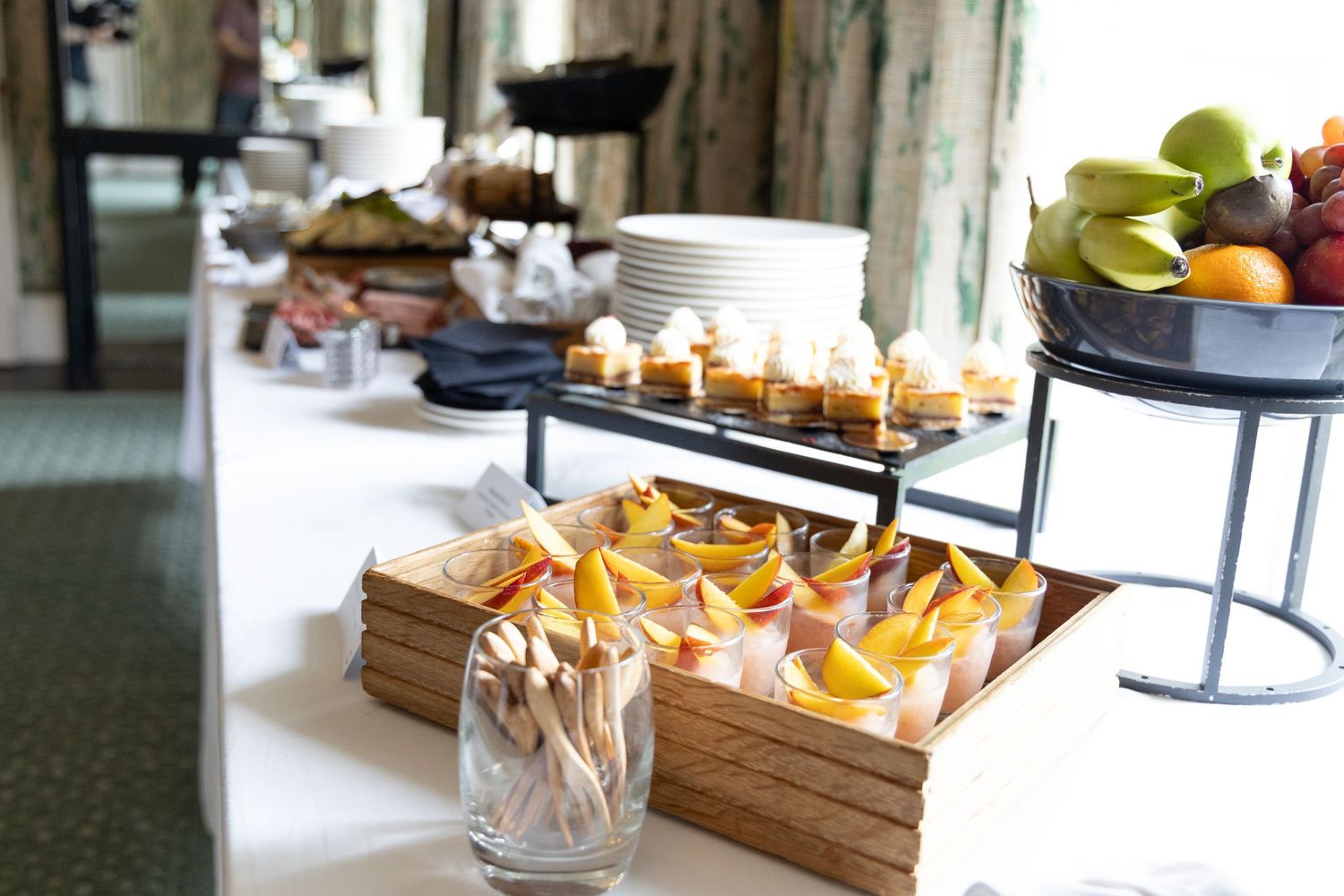 Wooden serving boards with assorted snacks and appetizers displayed on a minimalist table setup.