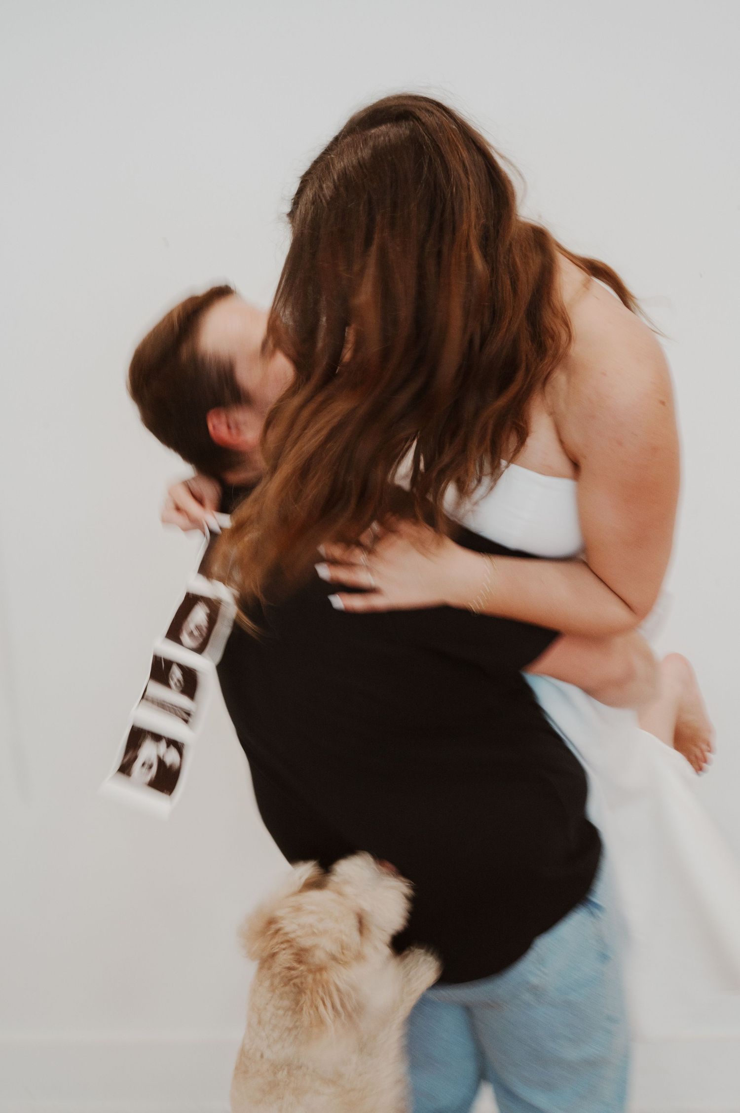 A sequence of tender embrace photos showing two figures in a romantic moment against a light background.