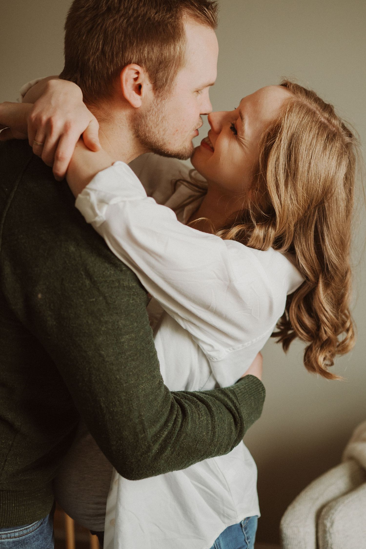 A tender moment captured in a series of intimate poses against a neutral backdrop.