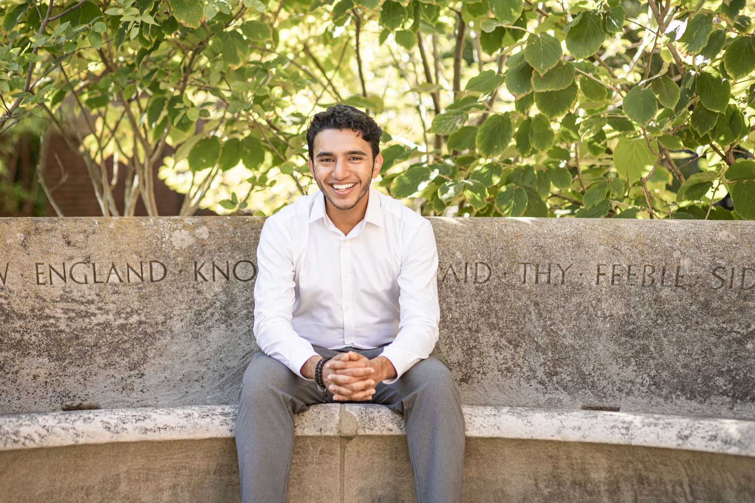 harvard graduate sitting in garden for photography session