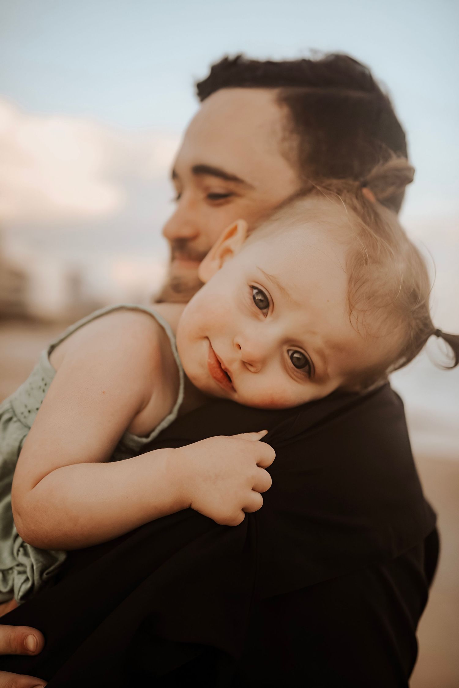 Close-up shots showing tender moments and expressions against a sunset backdrop.