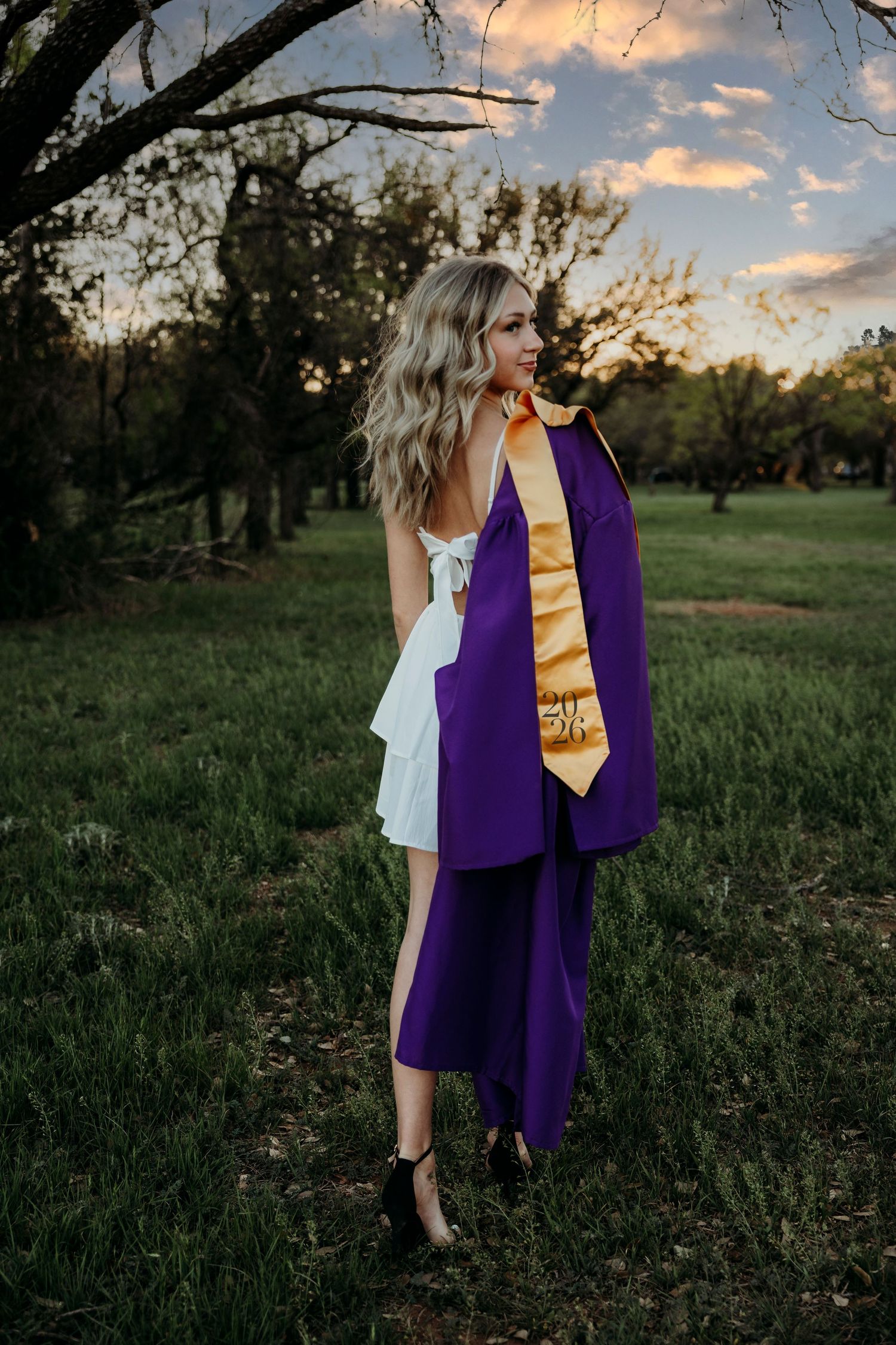 Cap and gown senior portraits in Abilene, TX during golden hour.