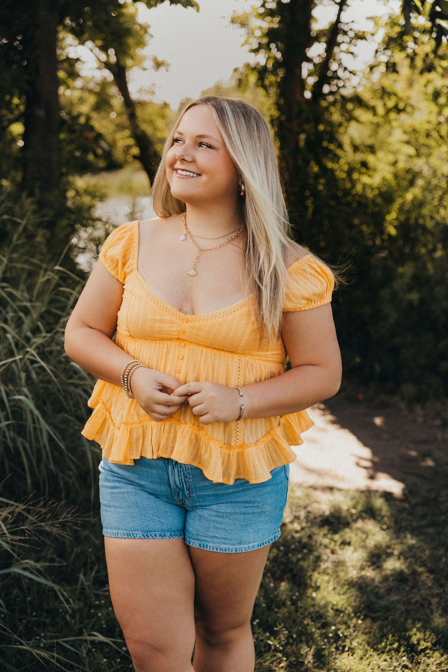 Outdoor senior photos of a Class of 2027 senior in a yellow top and cowboy boots during a golden hour senior portrait session in Abilene, Tx