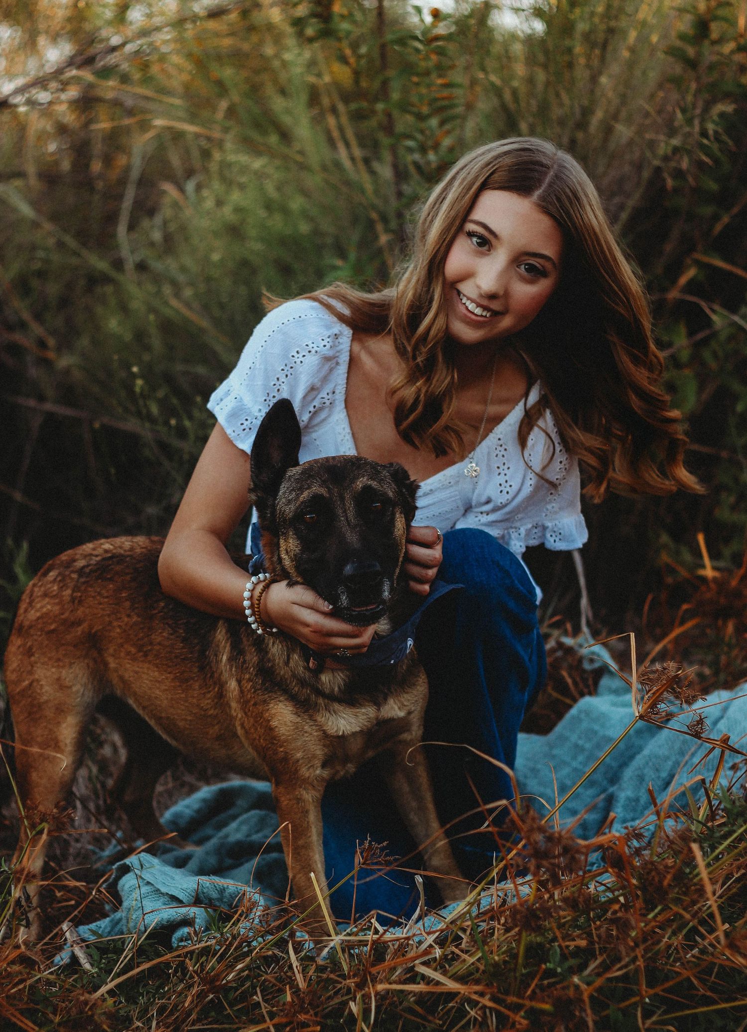 Abilene TX senior portrait session featuring a high school senior with her dog in a natural outdoor setting