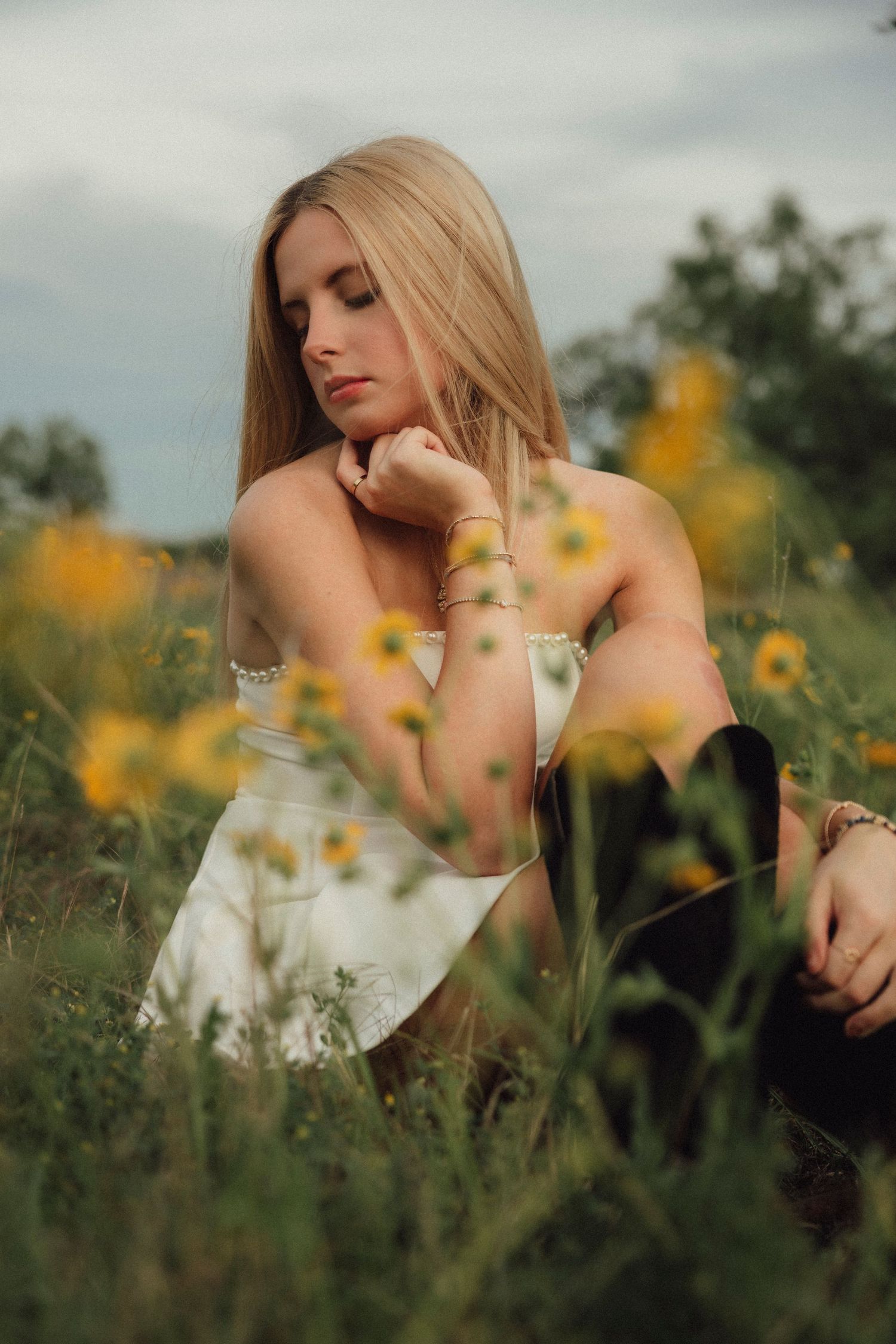Blonde high school senior portrait in wildflowers during golden hour in Abilene, Texas